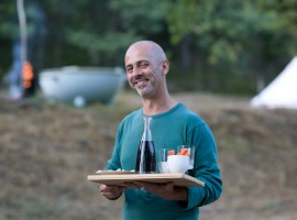 One of the owner of the accomodation showing some food that they offer to their guests