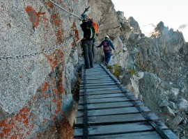 A little bridge in the rocky mountains and excursionists